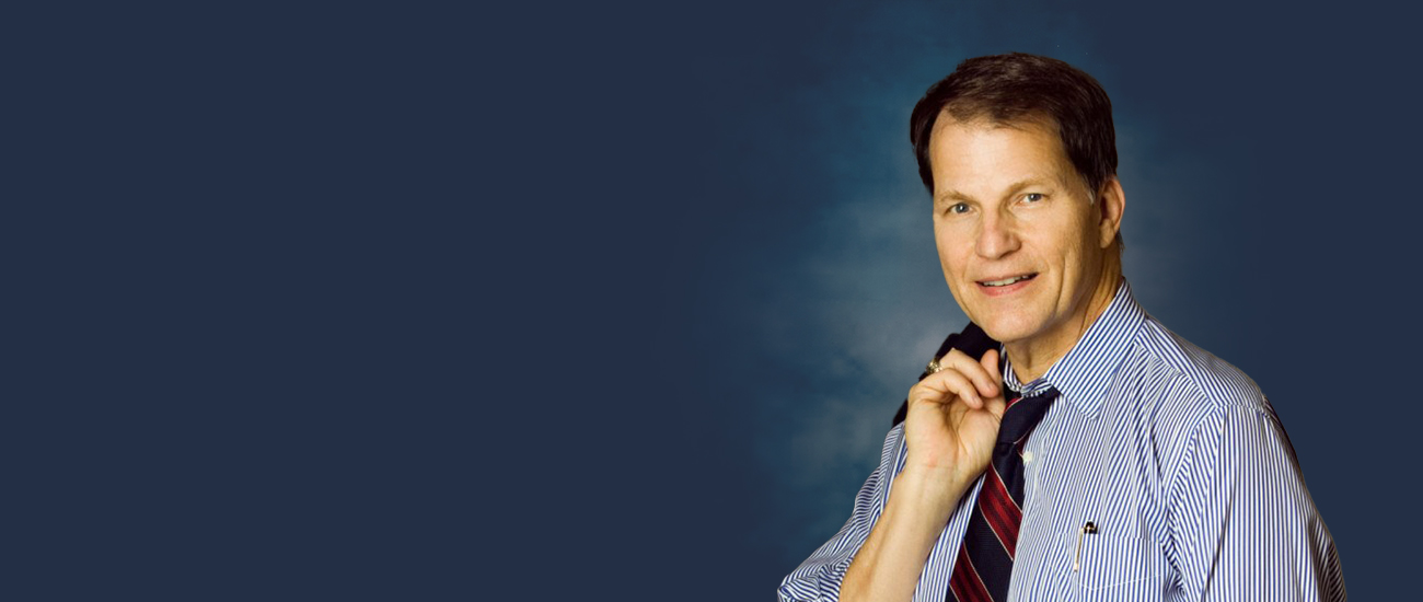 Contemplative man in suit with blue background